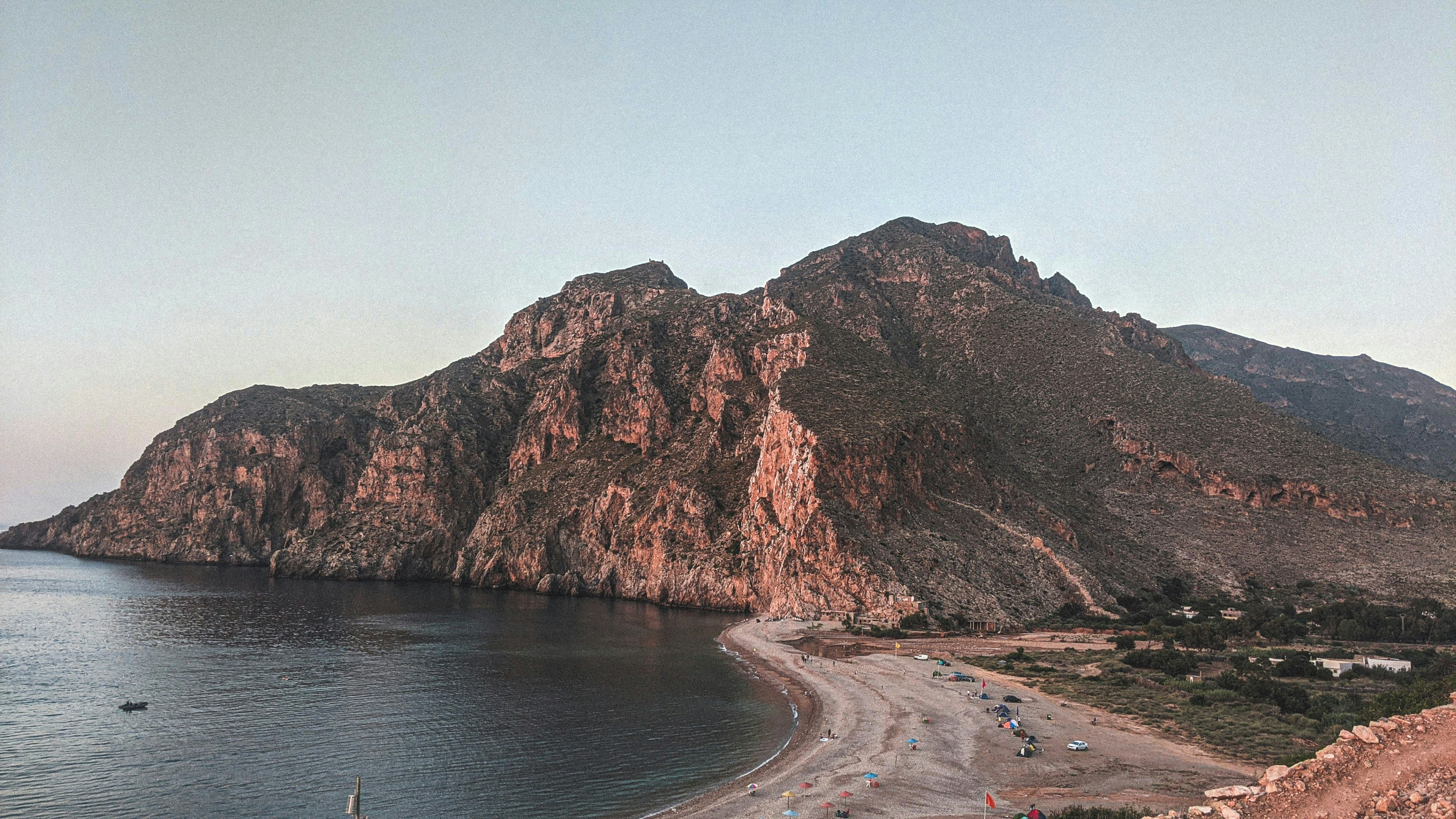 brown rock formation on sea water during daytime