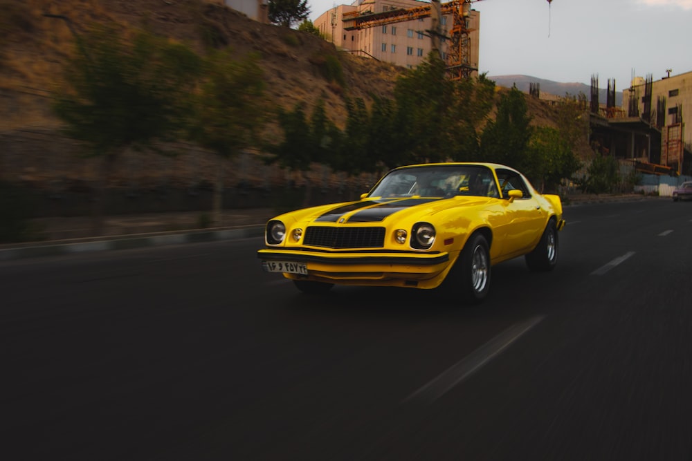 yellow porsche 911 on road during daytime