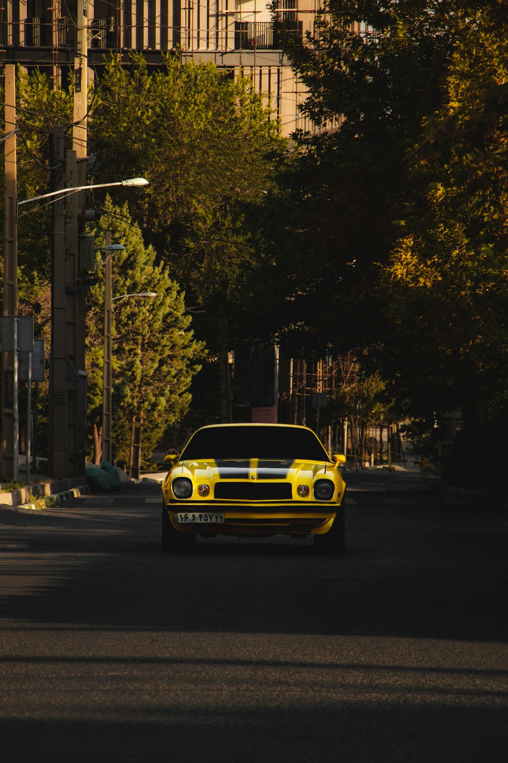 yellow chevrolet camaro on road during daytime