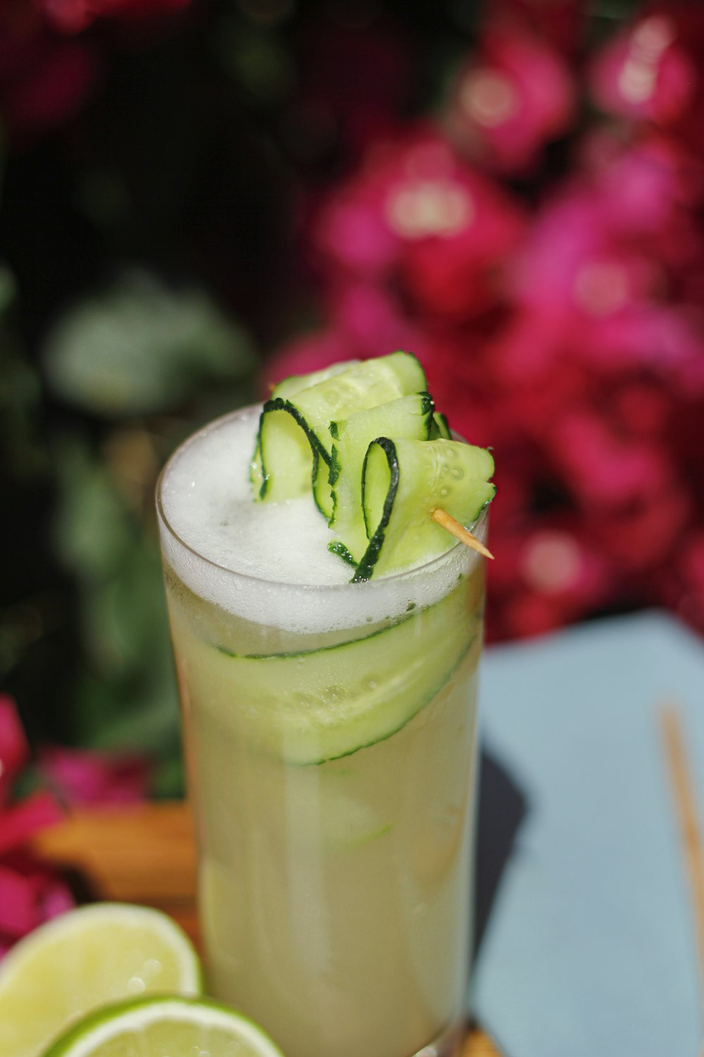 clear drinking glass with green liquid and sliced cucumber