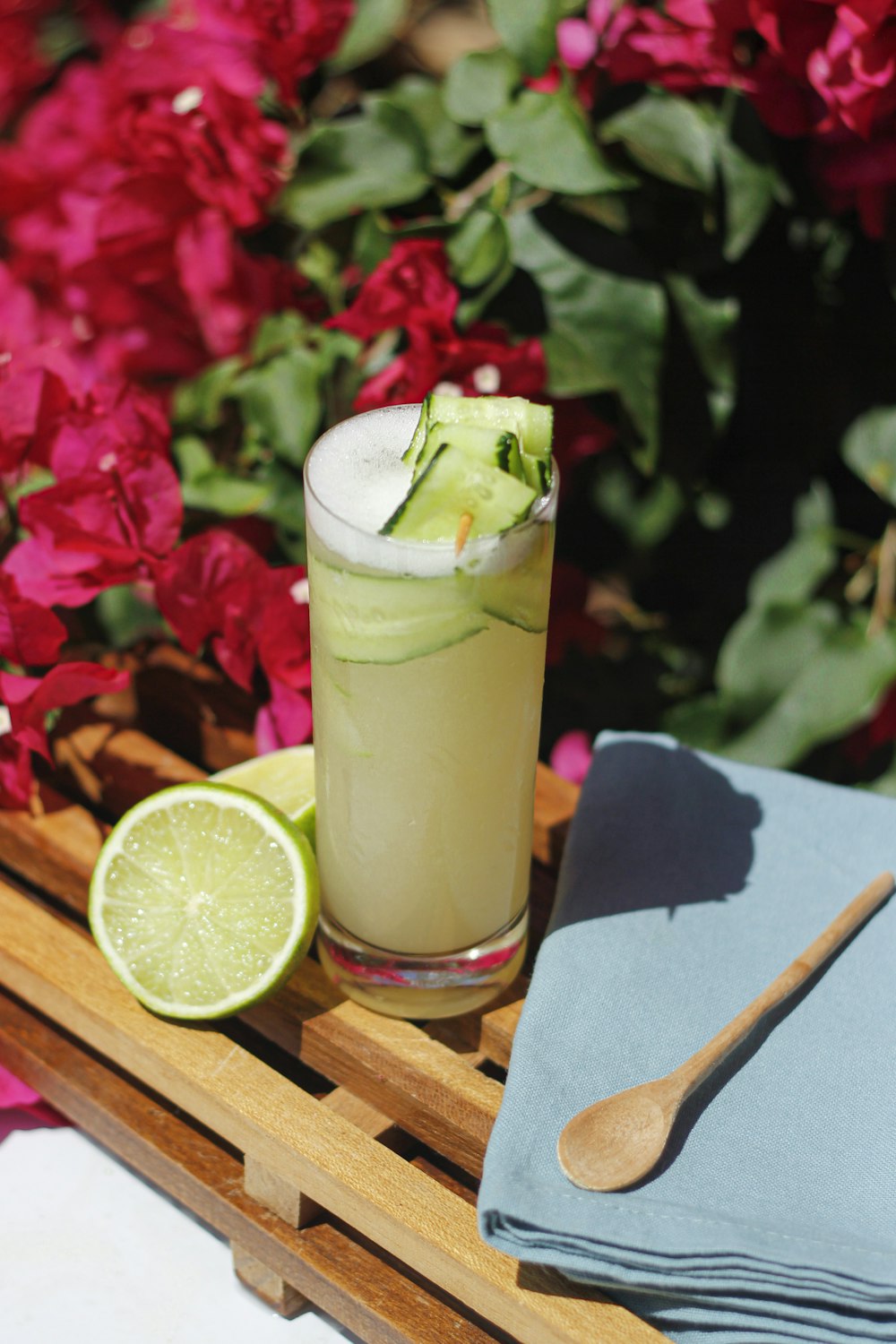 clear drinking glass with green liquid and sliced lemon