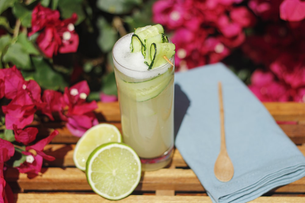 clear drinking glass with sliced lemon and white liquid