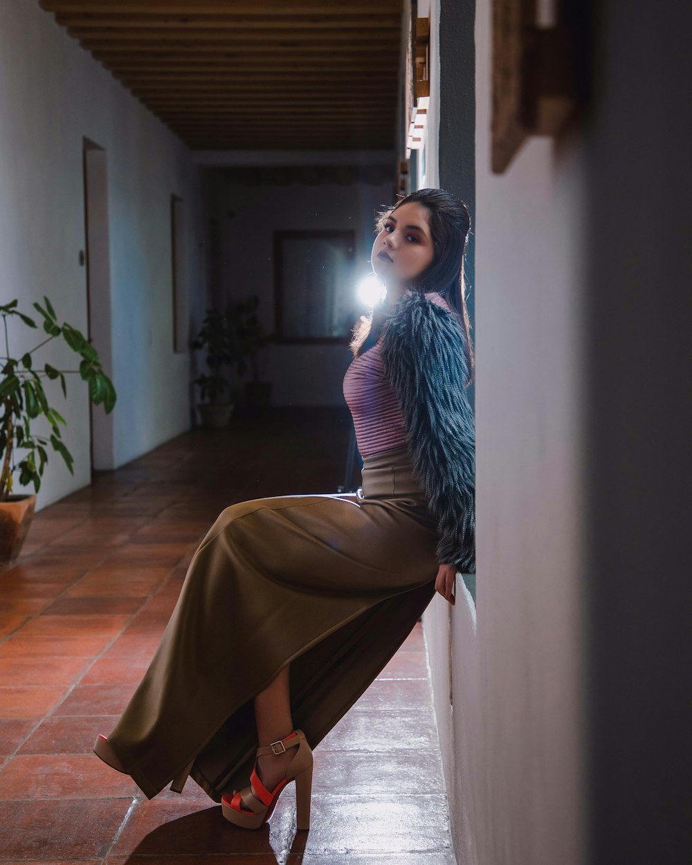 woman in purple long sleeve dress sitting on brown wooden seat