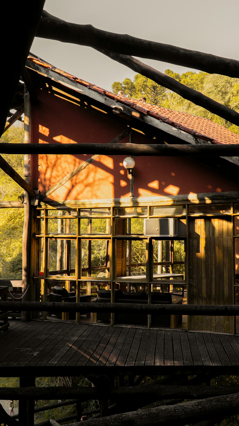 Braunes Holzhaus mit schwarzem Metalltor tagsüber