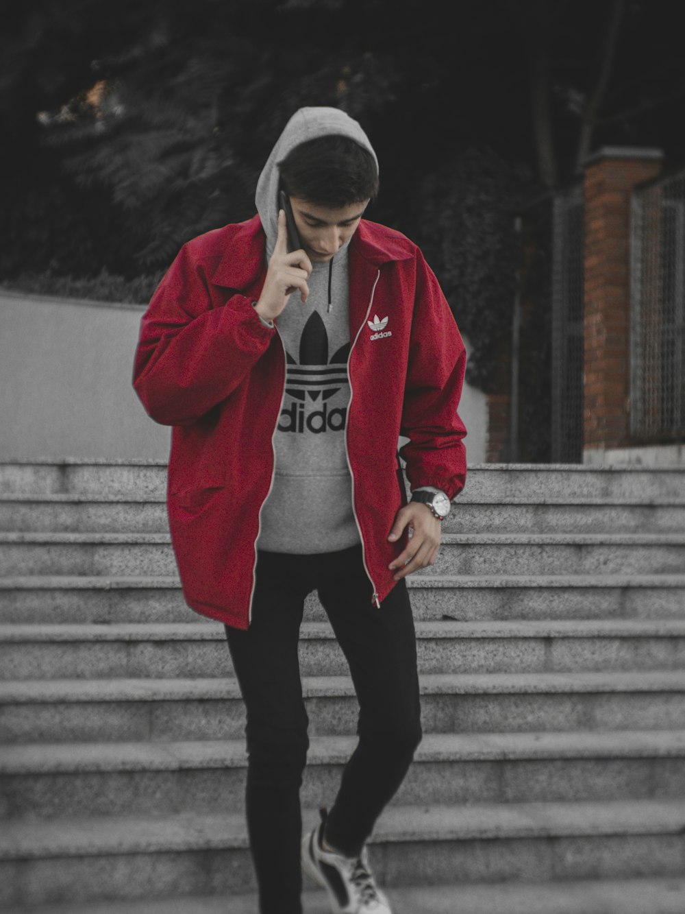 man in red hoodie and black pants standing on gray concrete stairs photo –  Free Clothing Image on Unsplash