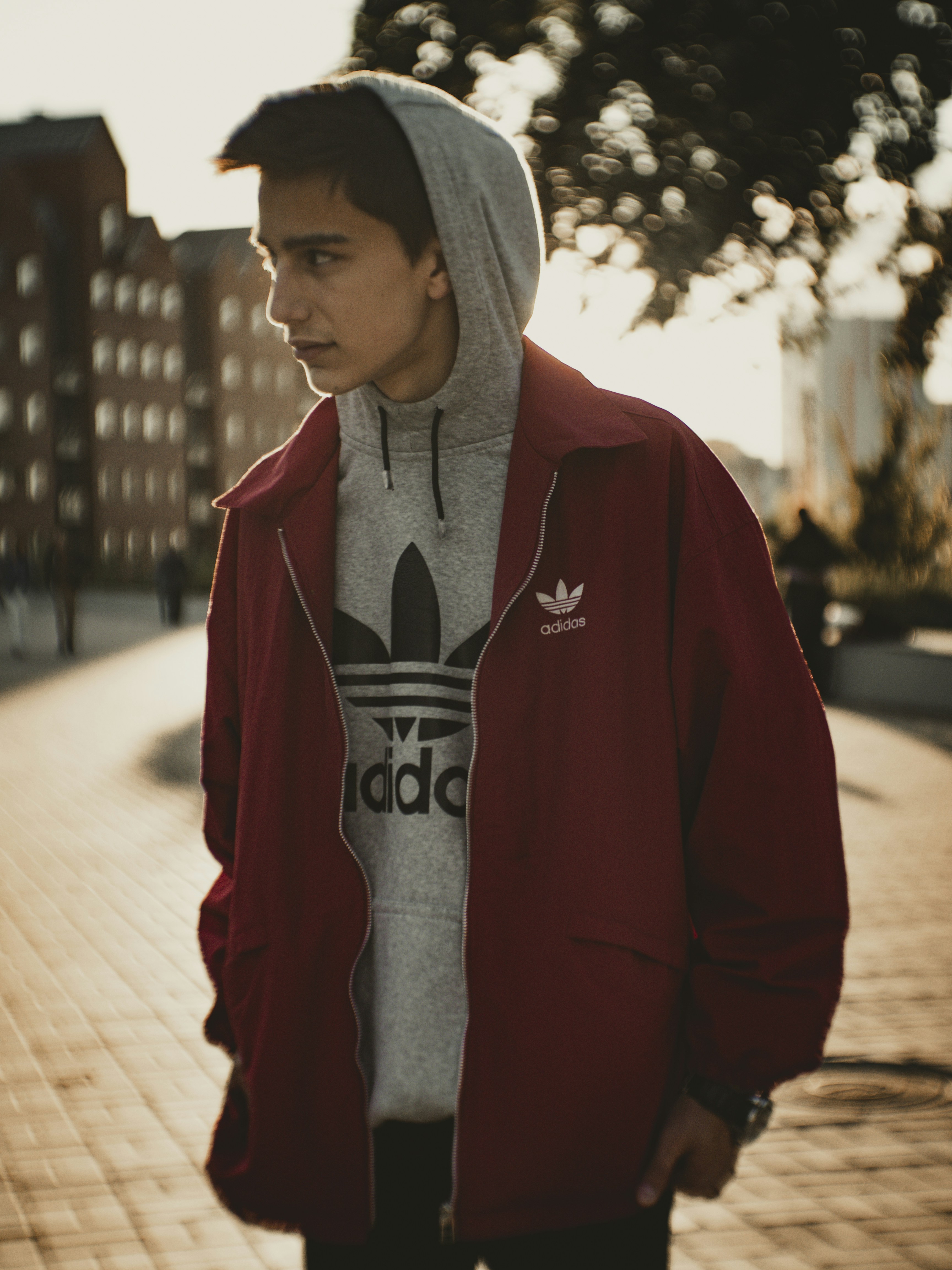 Man in red hoodie standing on sidewalk during daytime photo – Free Clothing  Image on Unsplash