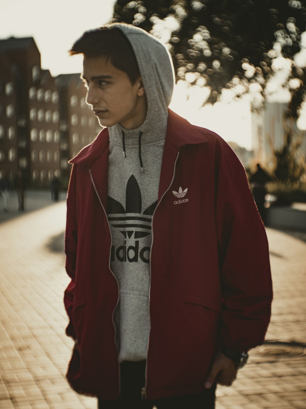 man in red hoodie standing on sidewalk during daytime photo – Free Clothing  Image on Unsplash