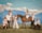 A group of people stands and sits on a grass field in front of a majestic mountain range under a blue sky with clouds. Two horses, one brown and one white, are present, with one person sitting on the brown horse. The group is dressed in coordinated light or white outfits, giving a harmonious and elegant look.
