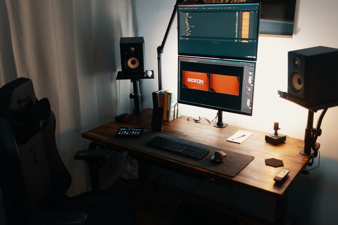 black flat screen computer monitor on brown wooden desk