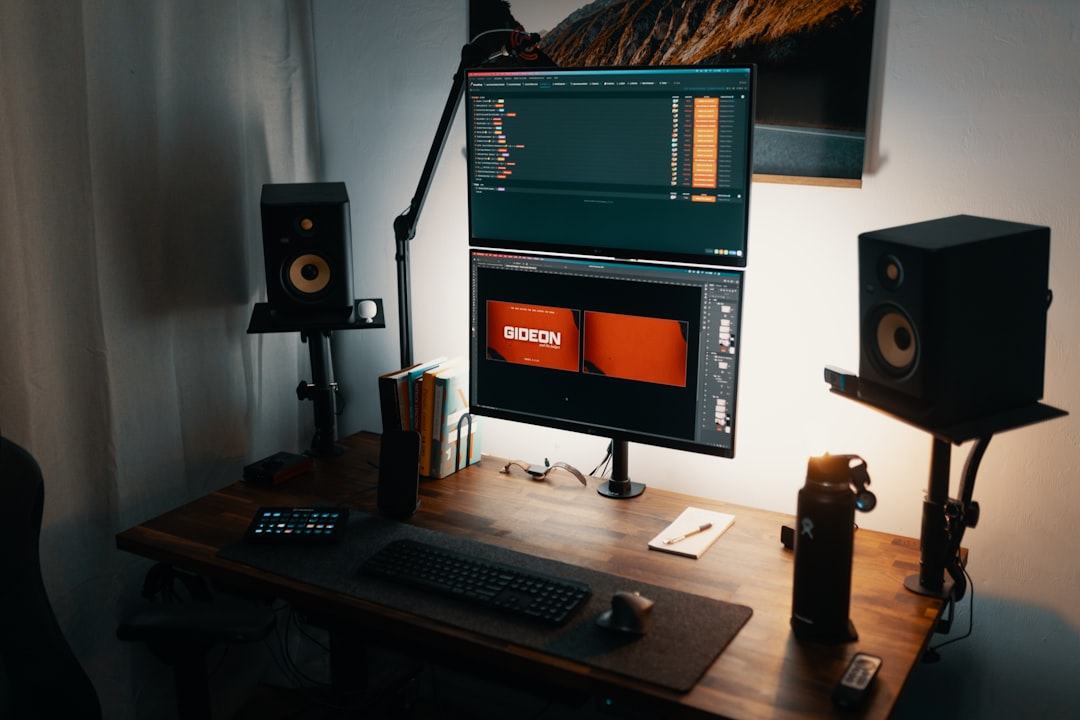 black flat screen computer monitor on brown wooden desk