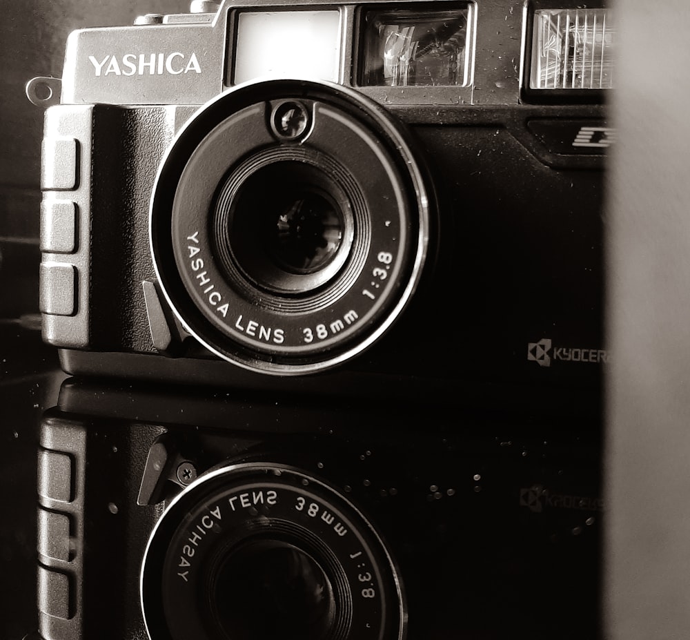 black and silver camera on white surface