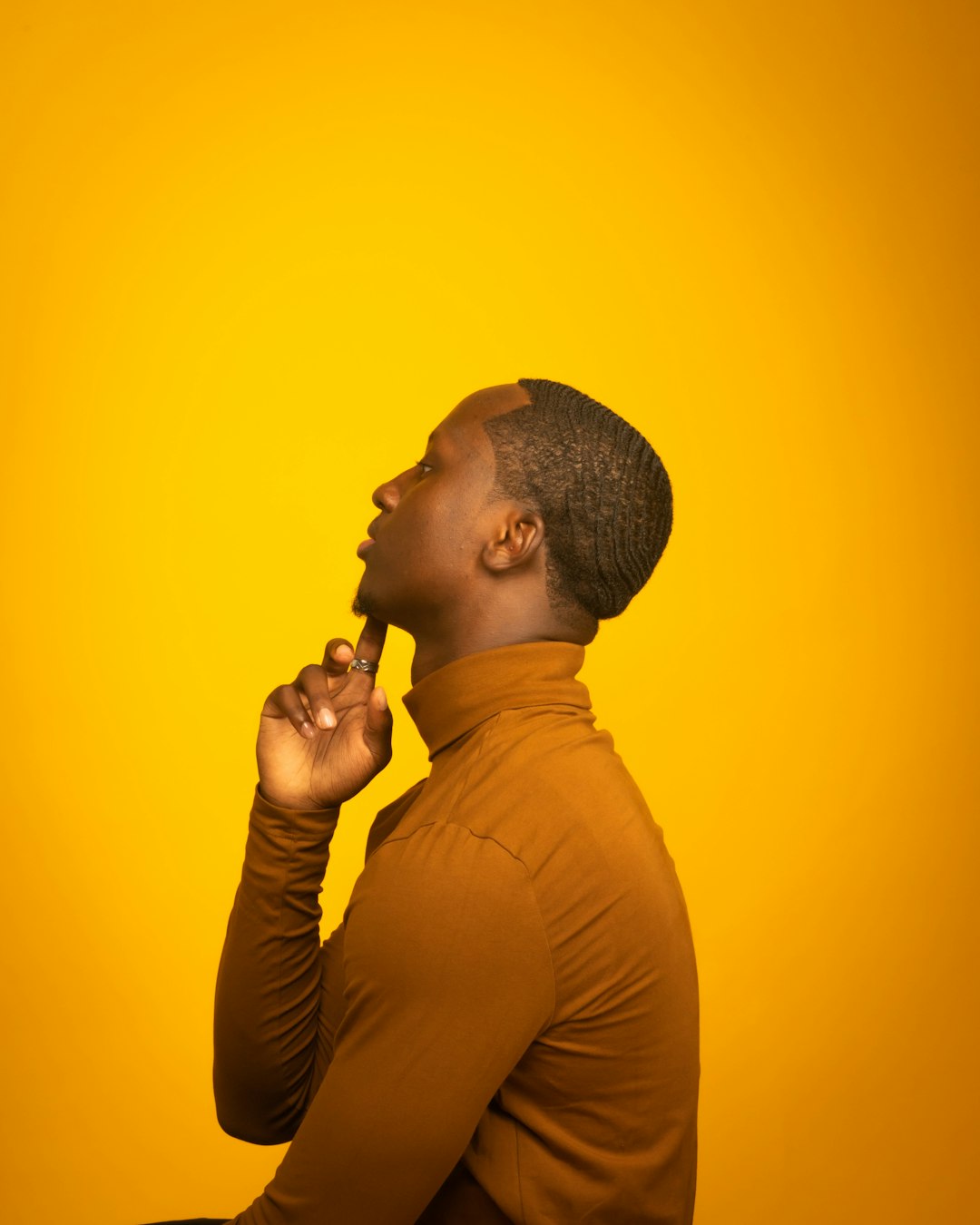 man in brown long sleeve shirt holding microphone