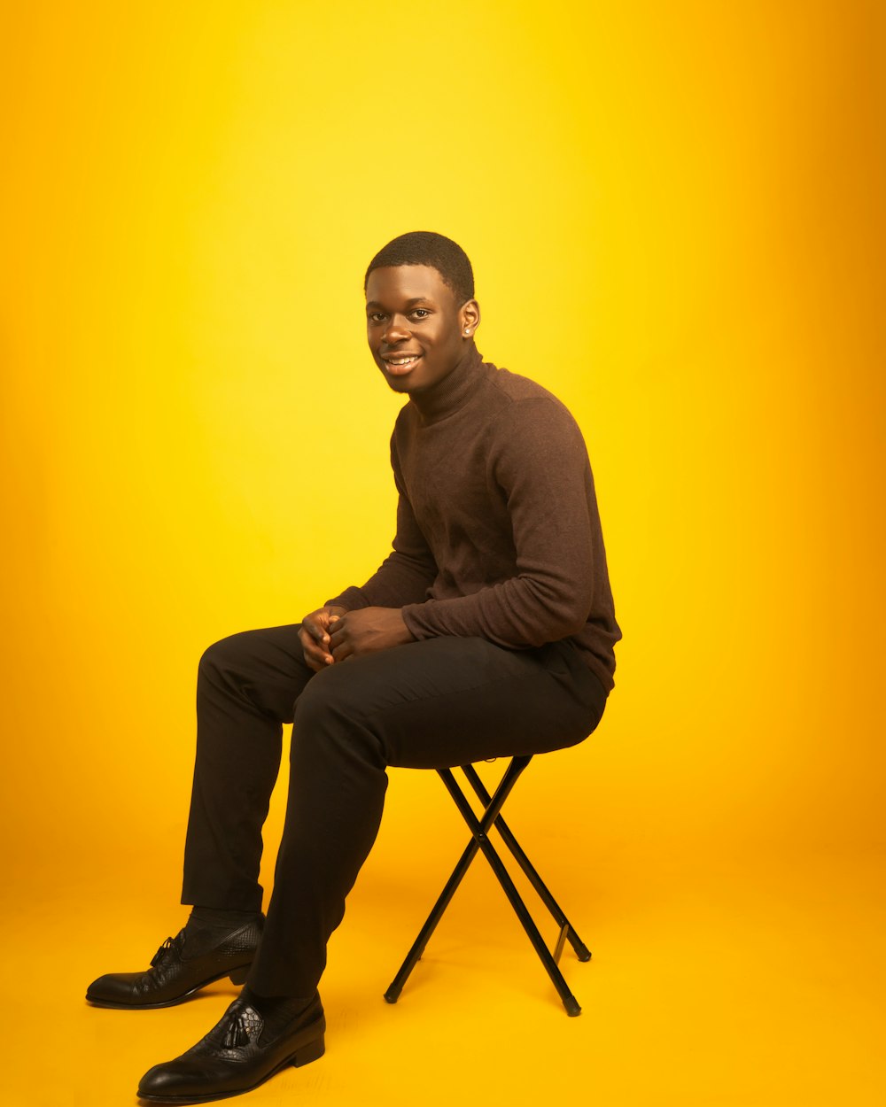 man in brown long sleeve shirt and brown pants sitting on chair