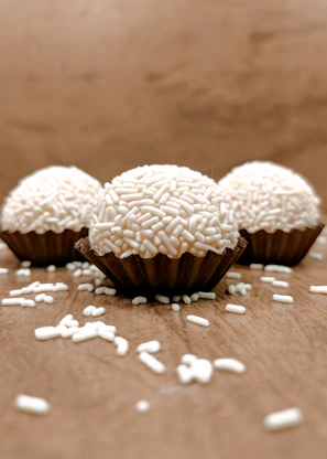 Close-up of healthy chocolate truffles with a sprinkle of nuts on a rustic wooden table