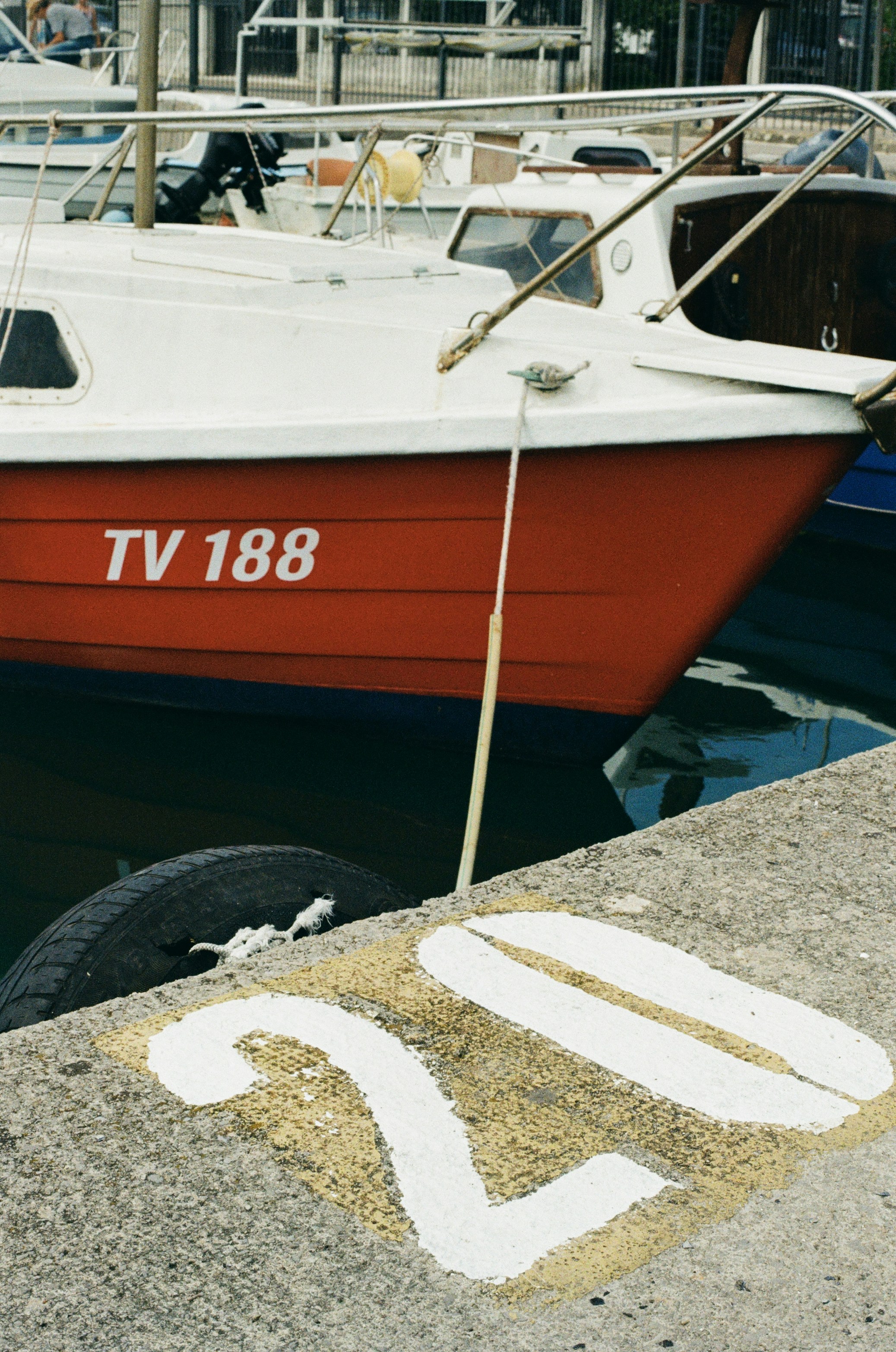 Red and white boat on dry dock showing hull markings