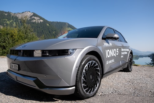 Kinetiq batteries powering an electric vehicle on a scenic road, symbolizing sustainable energy.