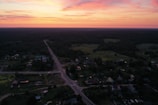 Sunset view over a quiet village road where the traveler rests.