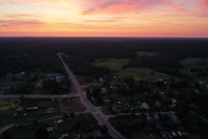 A warm sunset over a quiet village surrounded by nature.