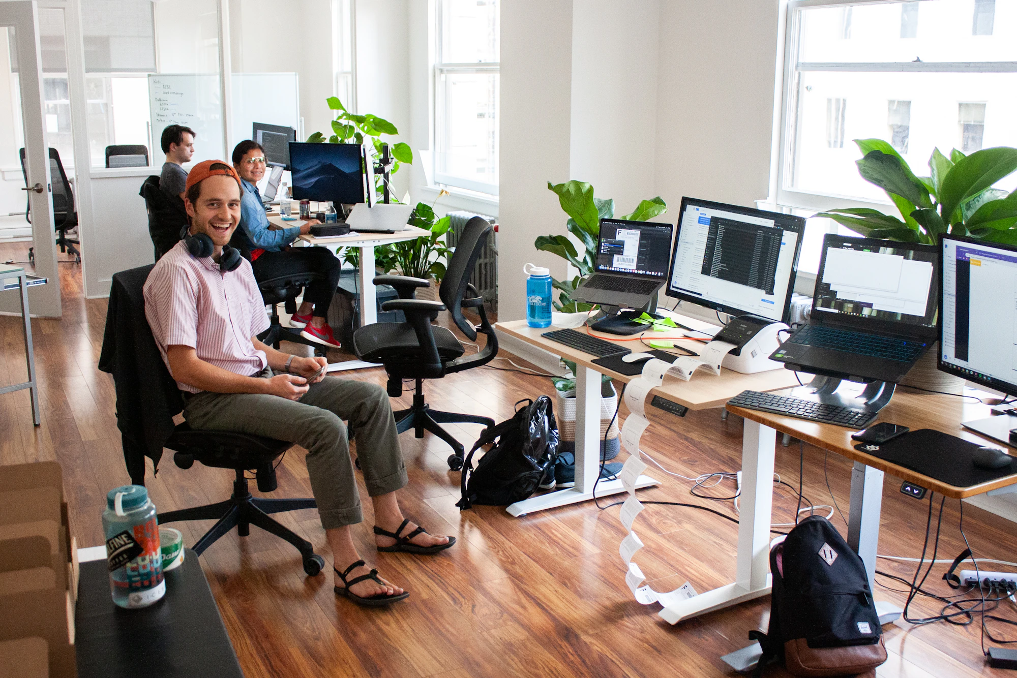 A bright, modern engineering office with monitors and daylight