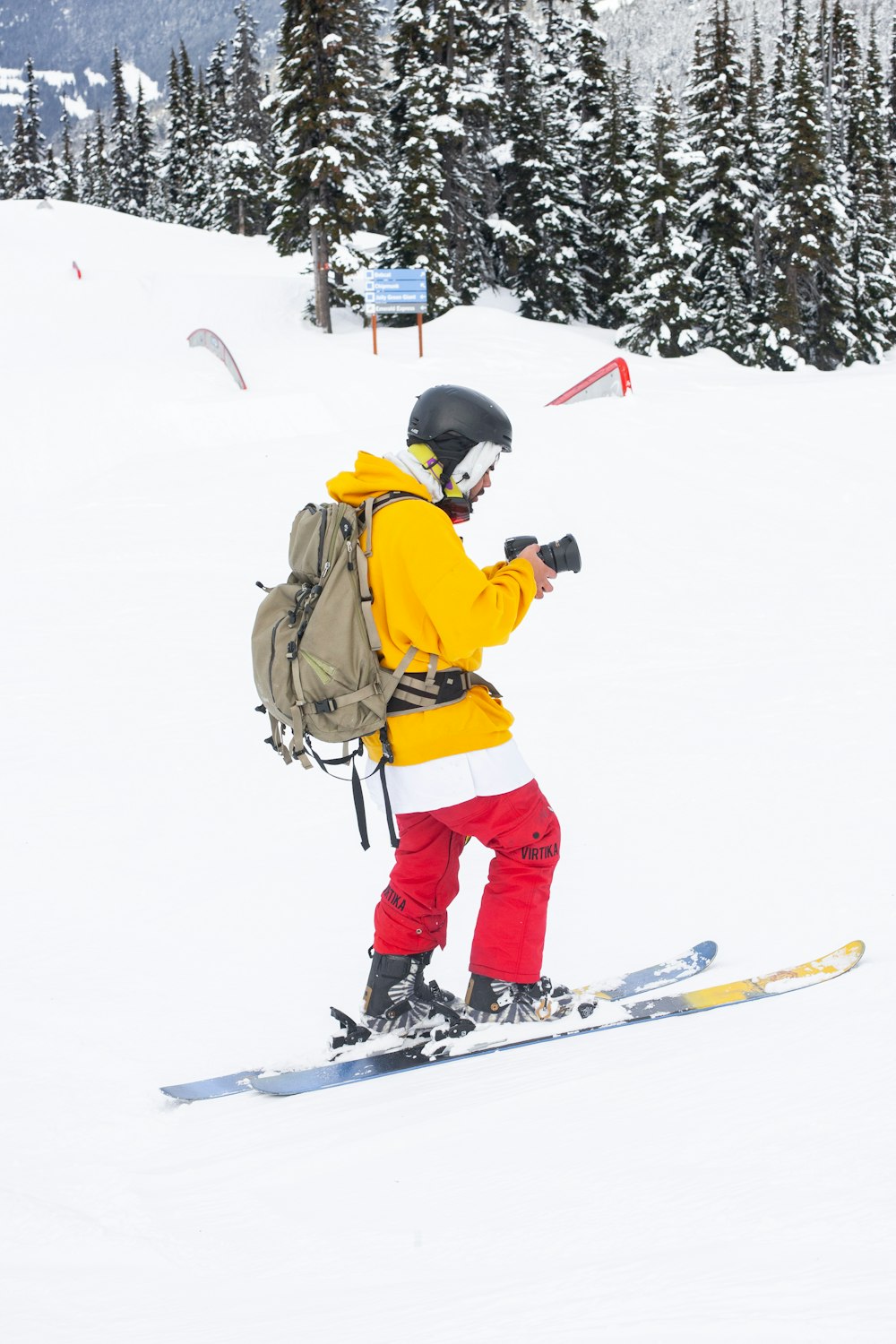 man in brown jacket and black pants riding on snowboard during daytime