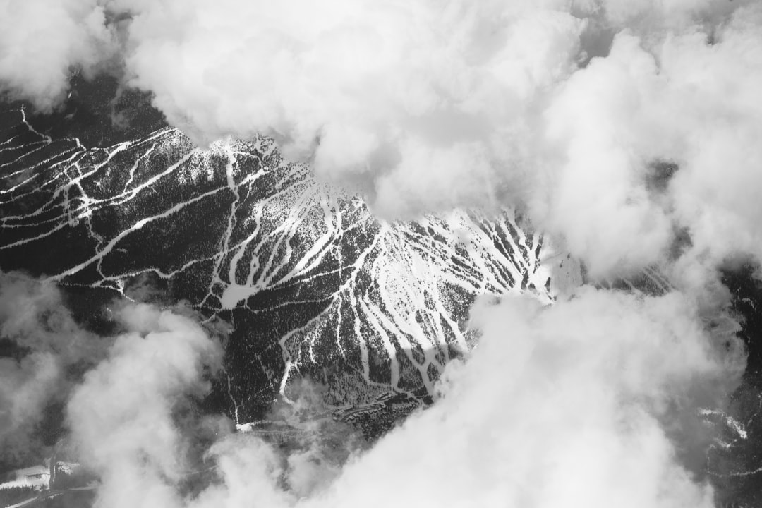 grayscale photo of clouds on mountain