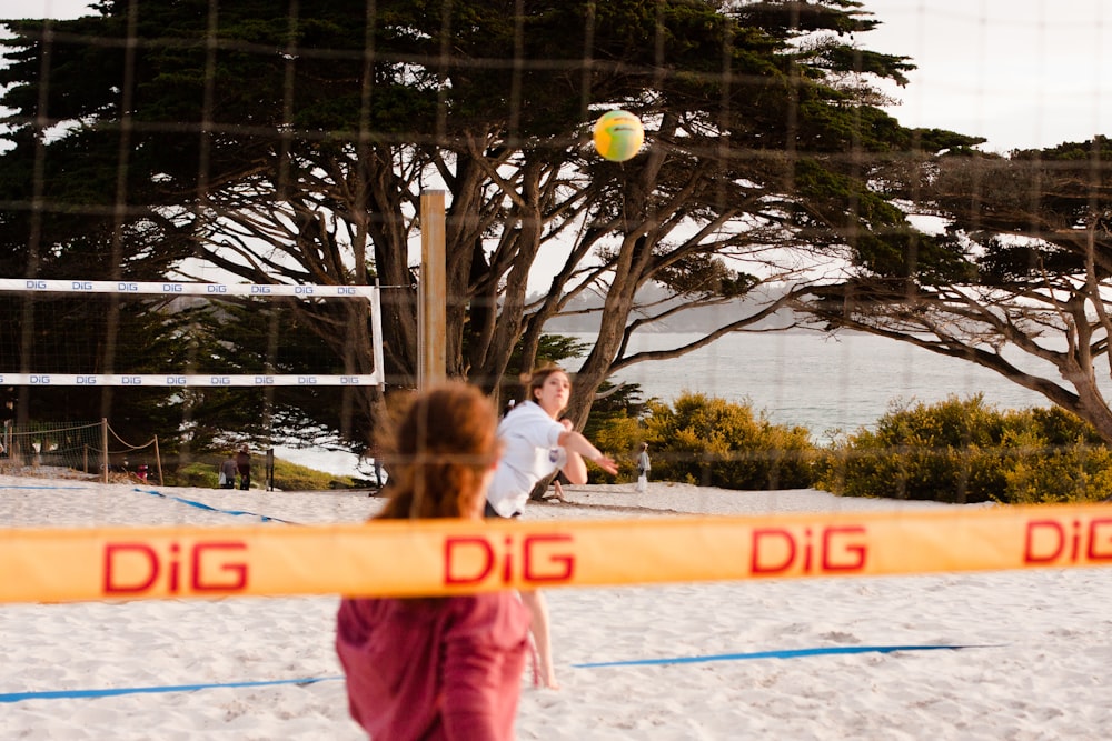 girl in pink shirt playing soccer during daytime