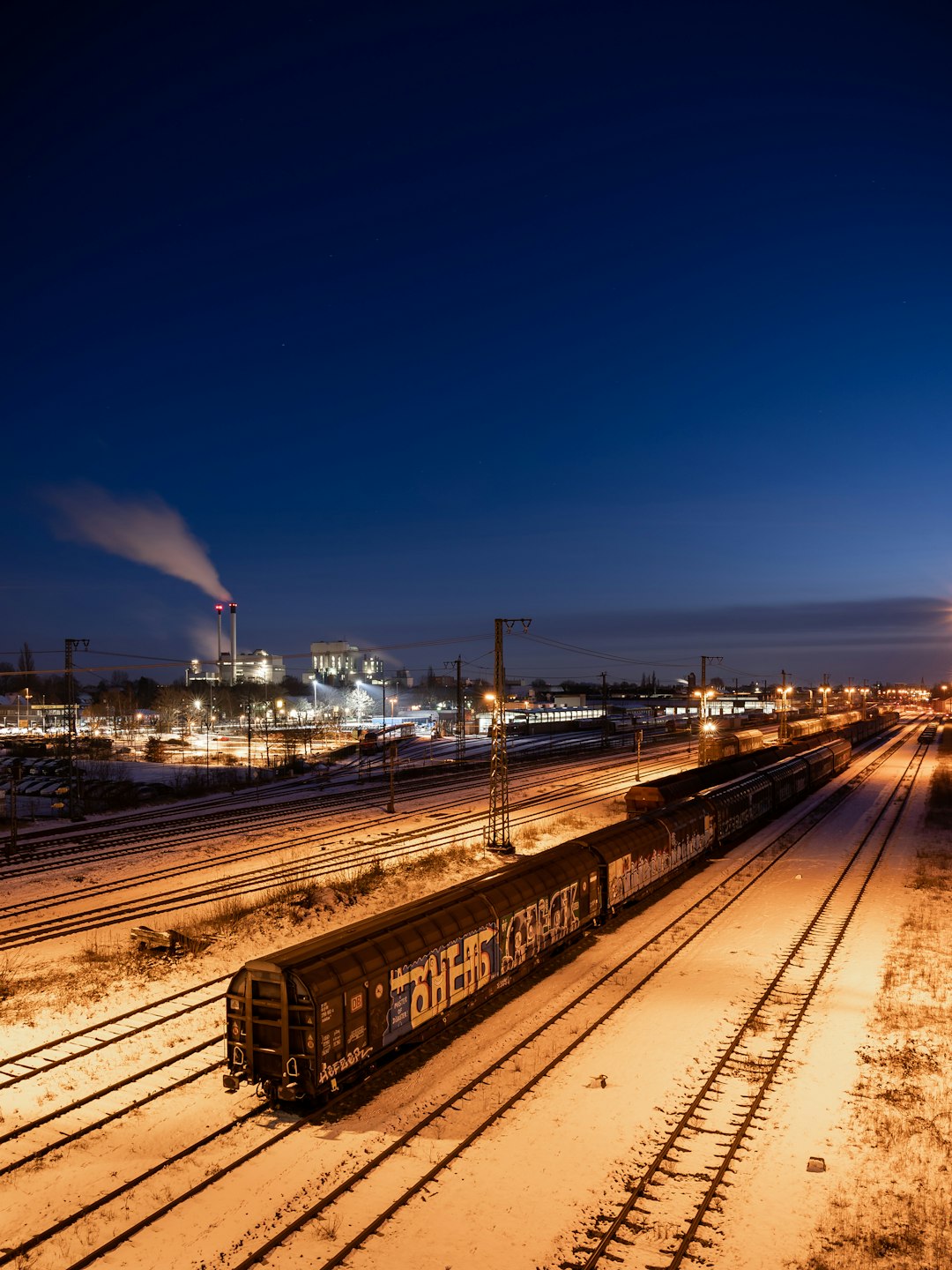 train rail near city buildings during night time