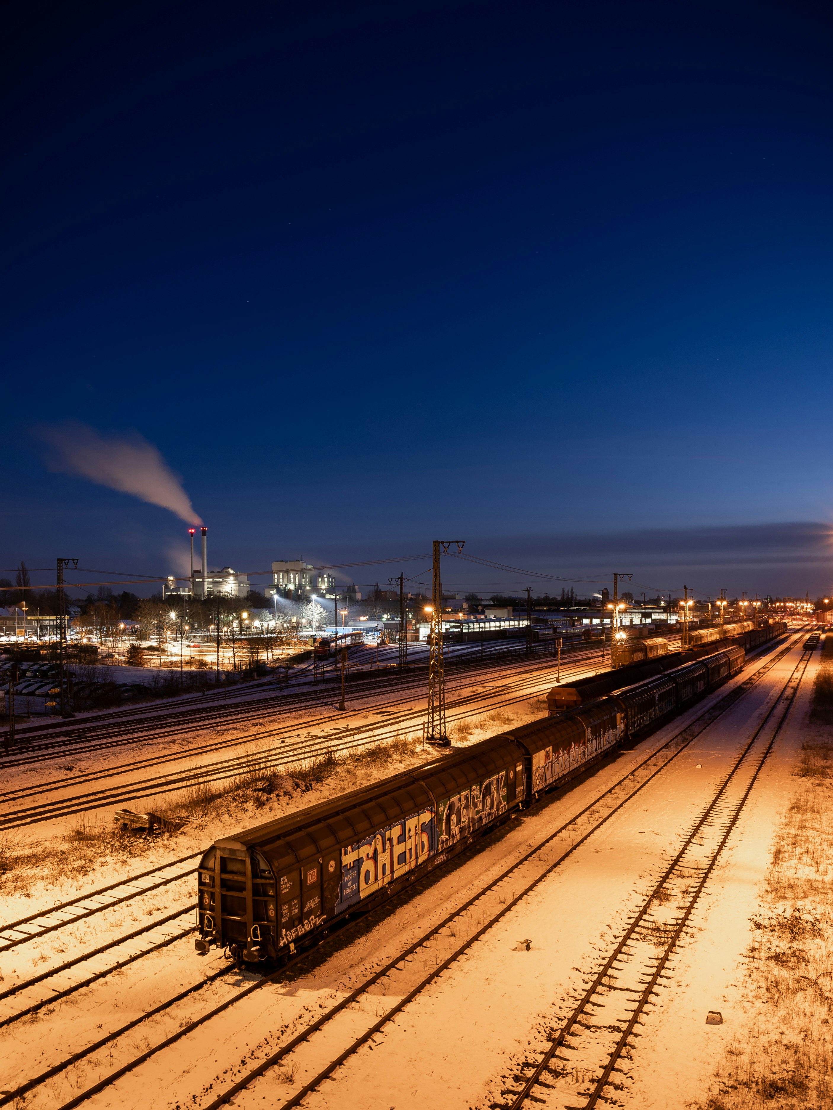 train rail near city buildings during night time