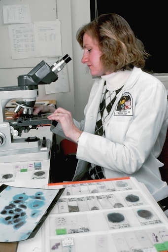 woman in white long sleeve shirt using white and black machine