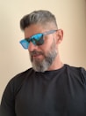 man in black crew neck shirt wearing blue sunglasses