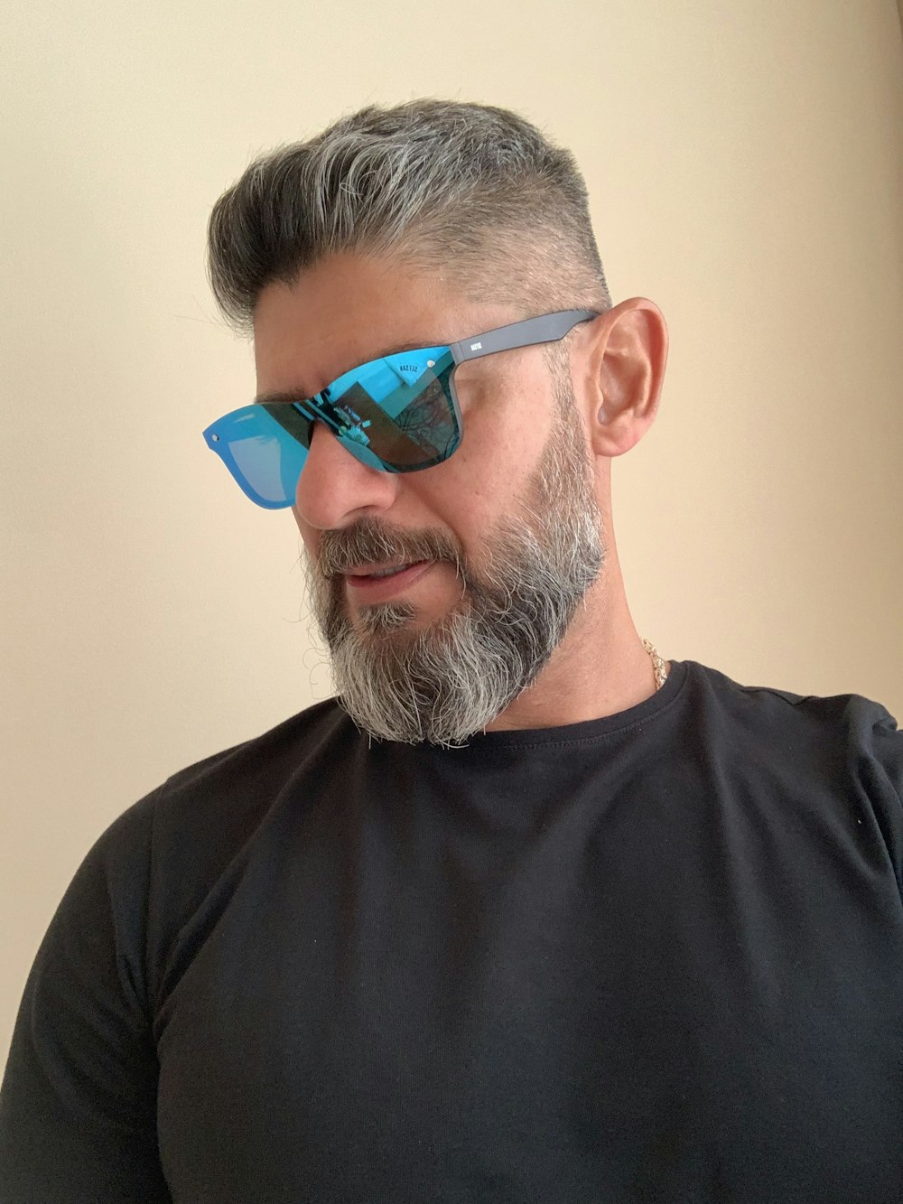 man in black crew neck shirt wearing blue sunglasses