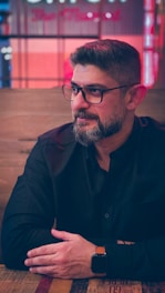 man in black button up shirt wearing eyeglasses