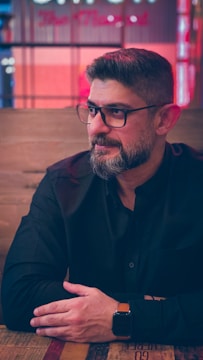 man in black button up shirt wearing eyeglasses