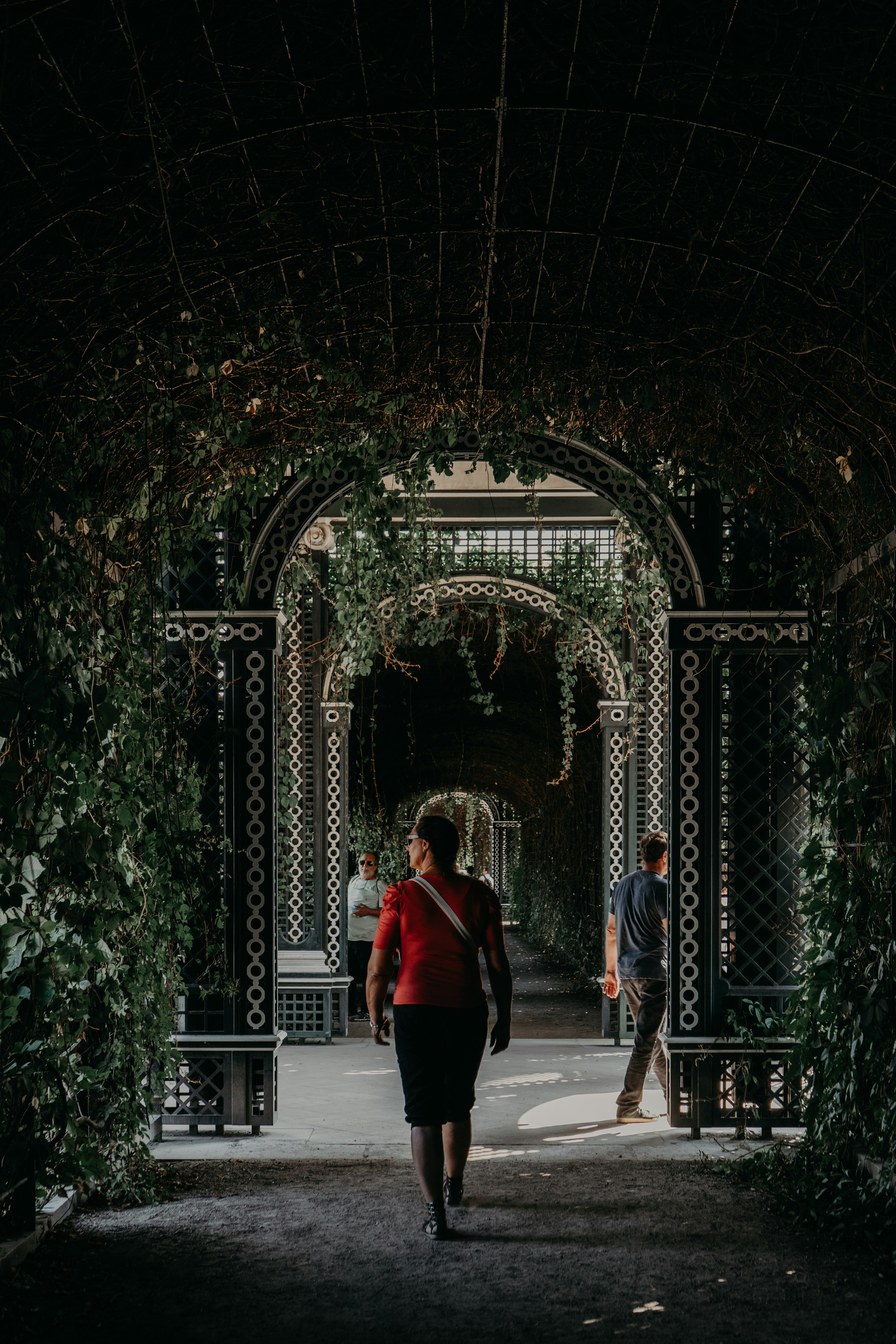 woman in red jacket standing in front of gate