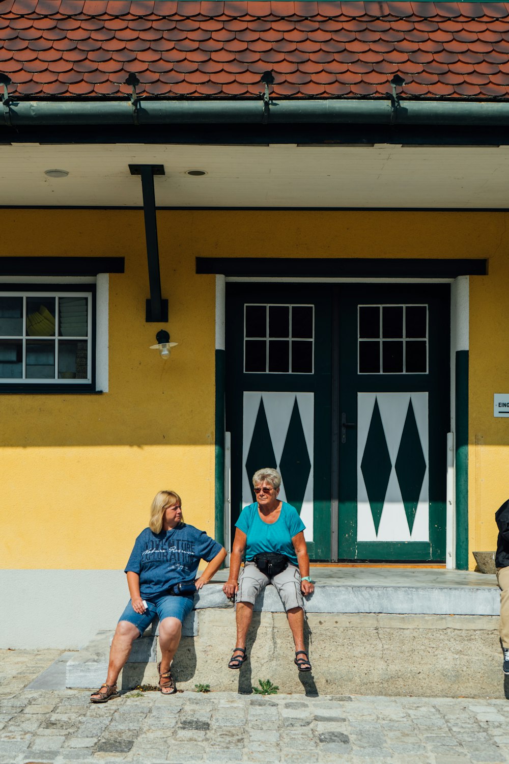 man in blue polo shirt sitting beside woman in blue shirt