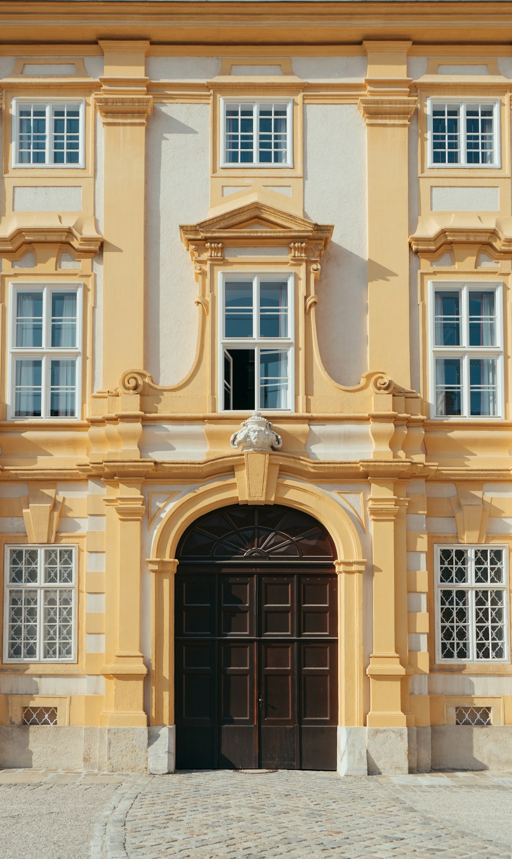 brown concrete building with black window