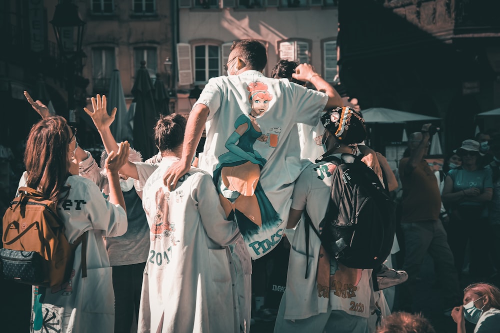 man in white robe standing on street during daytime