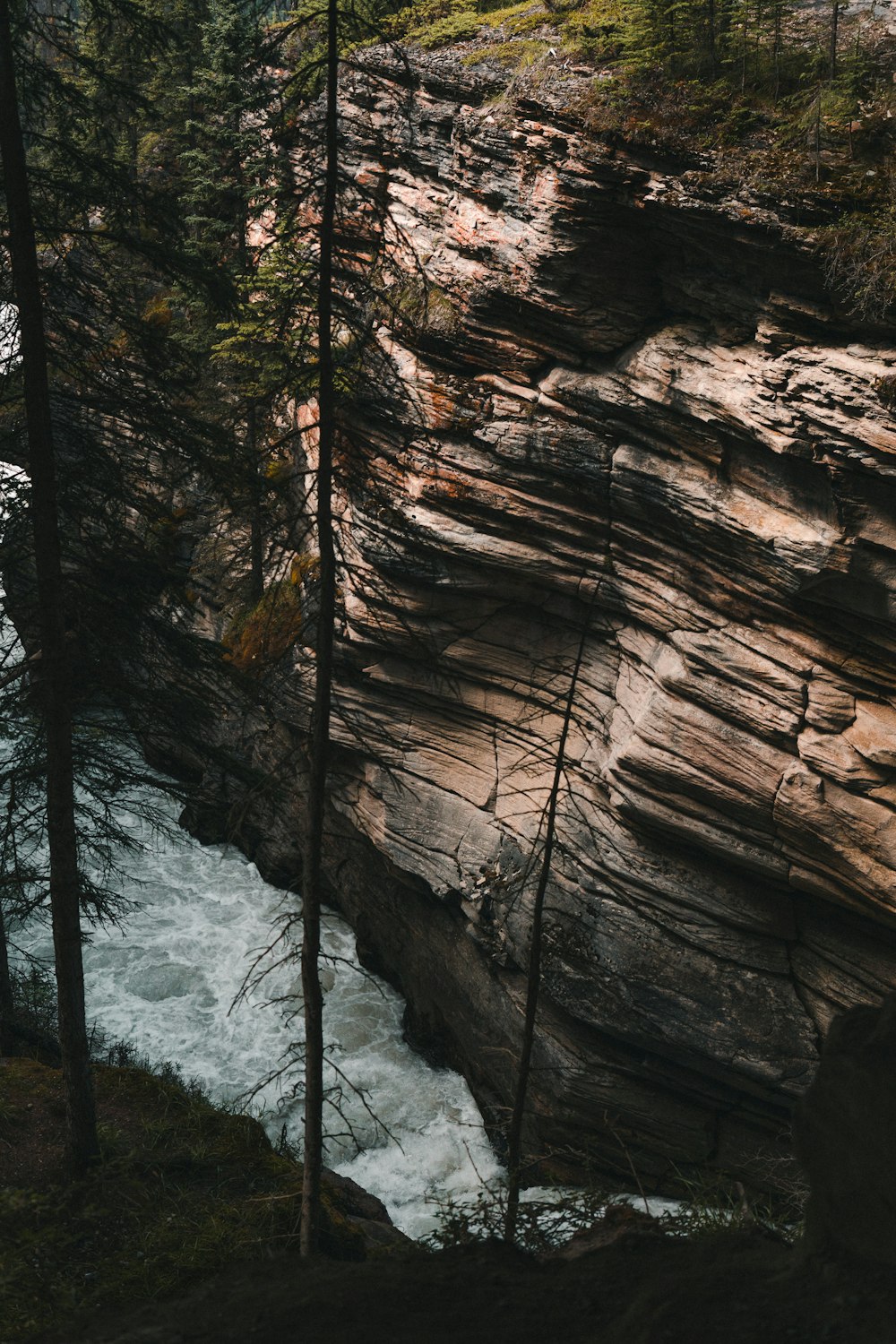 brown rock formation with water falls