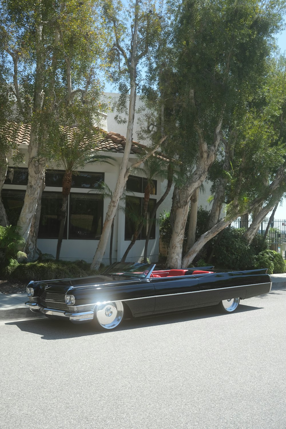 a classic car parked in front of a house