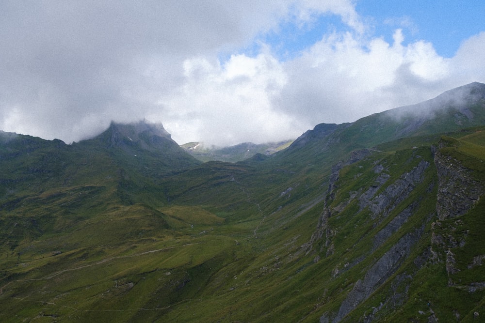 green mountains under white clouds during daytime