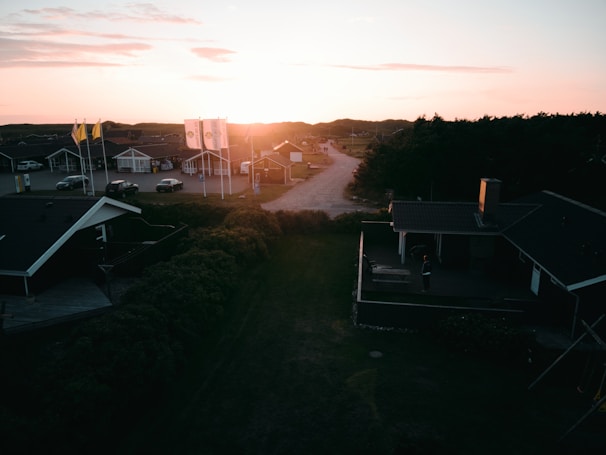 Sunset casting warm light over a quiet Summerlin neighborhood street lined with upscale homes.