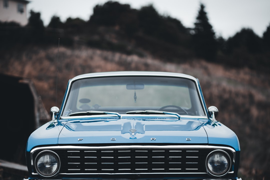 blue car on brown dirt road during daytime