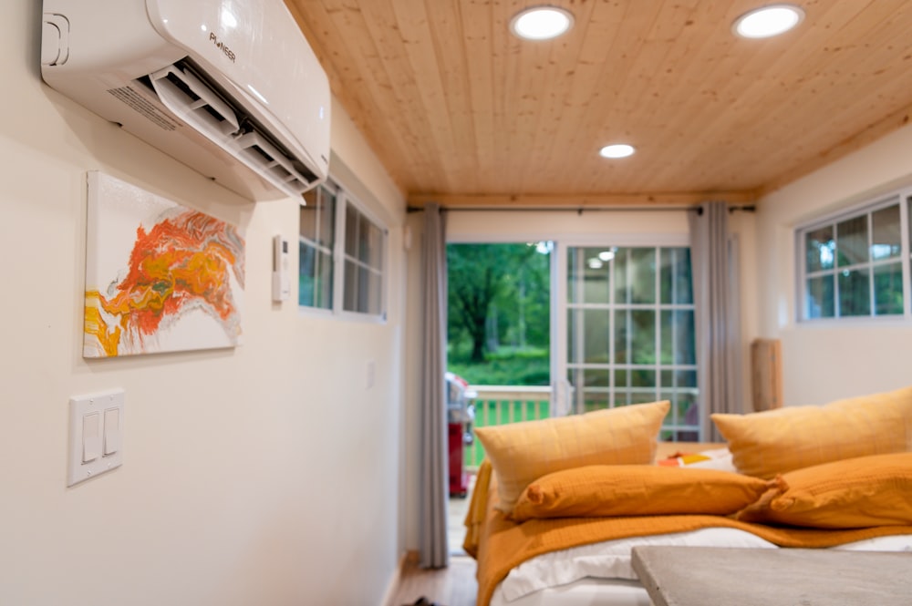 a bedroom with a bed and a air conditioner