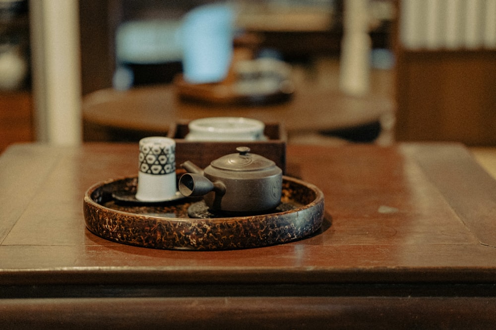 white and black ceramic mugs on brown wooden tray