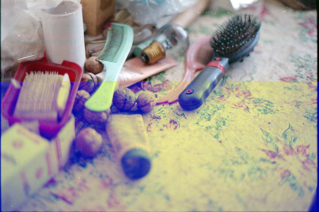 blue hair brush beside white hair brush