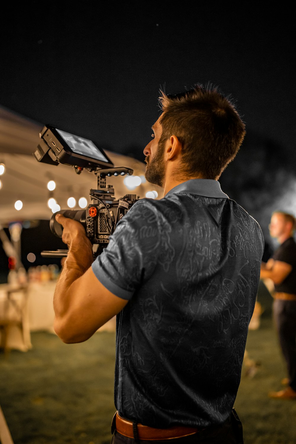 man in black t-shirt holding microphone