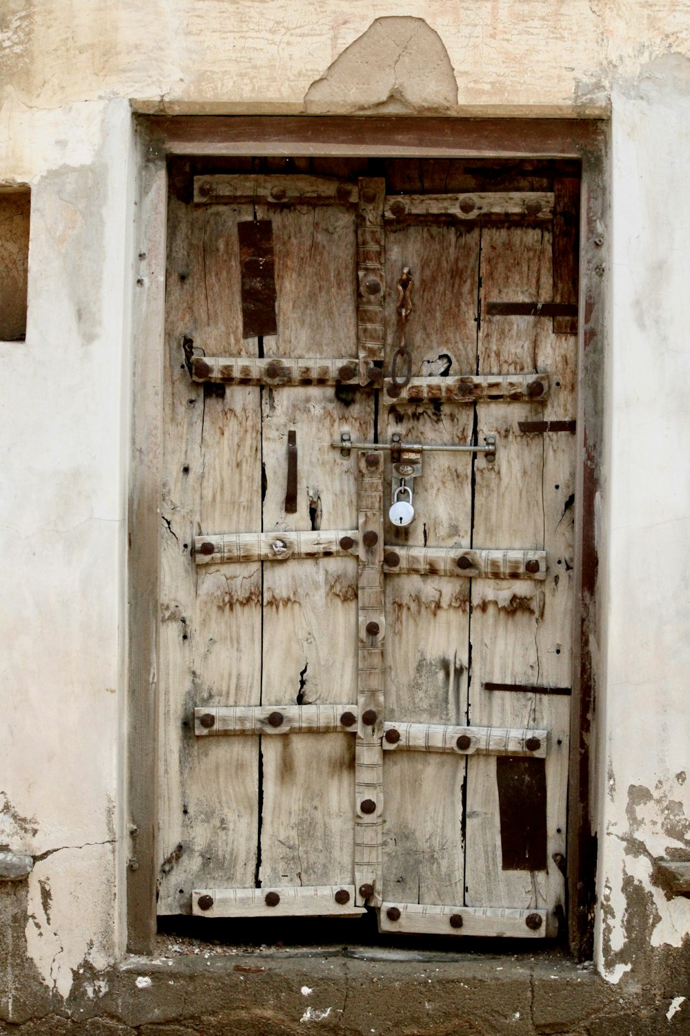 brown wooden door with cross