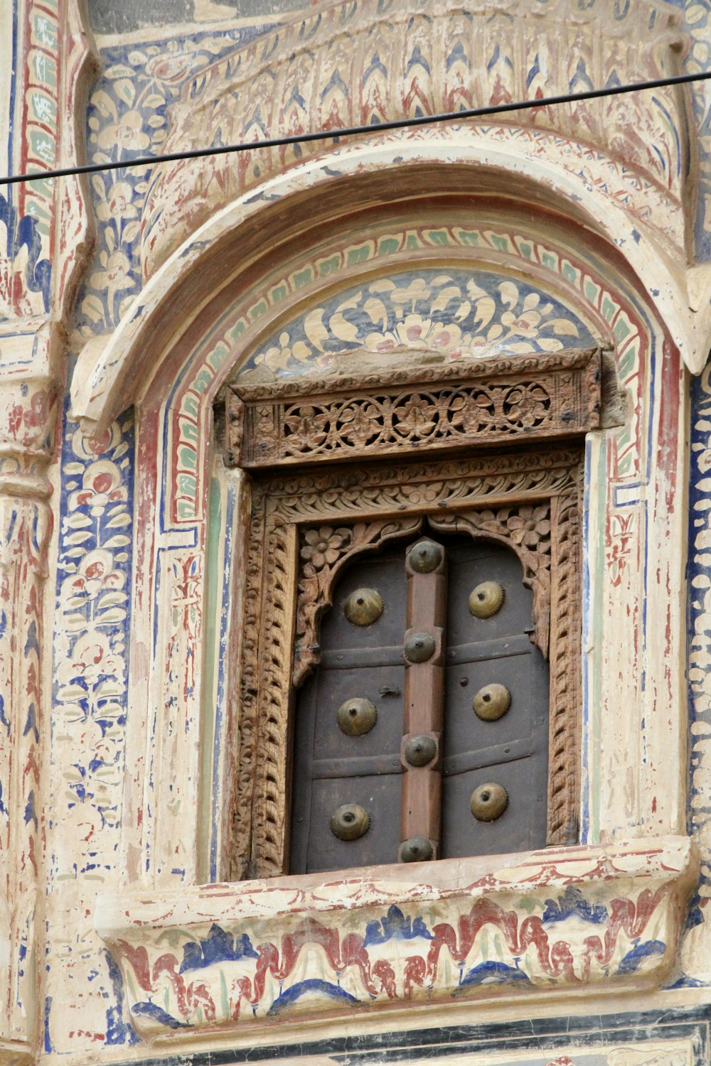 brown wooden door with gold door lever