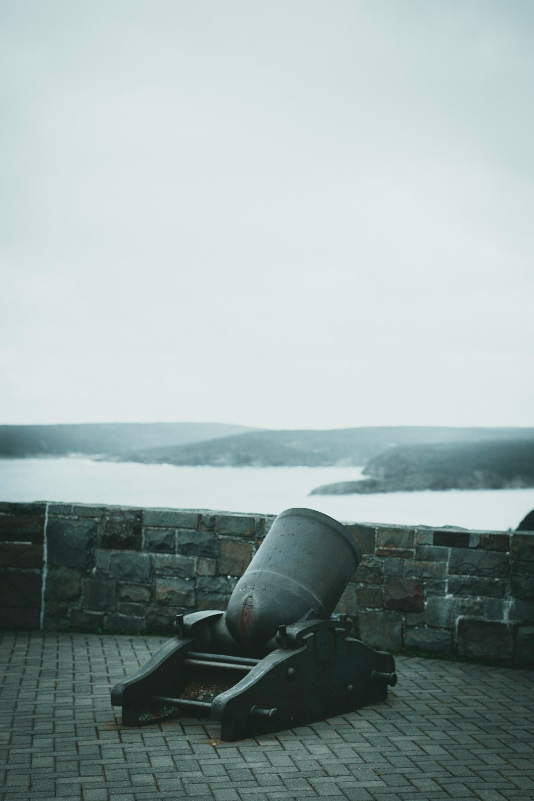 black canon on gray concrete wall