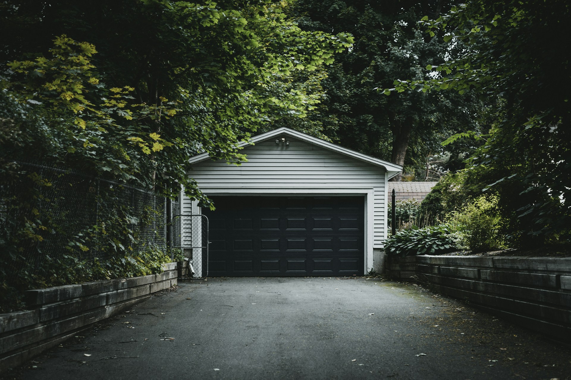 gray wooden house near green trees during daytime